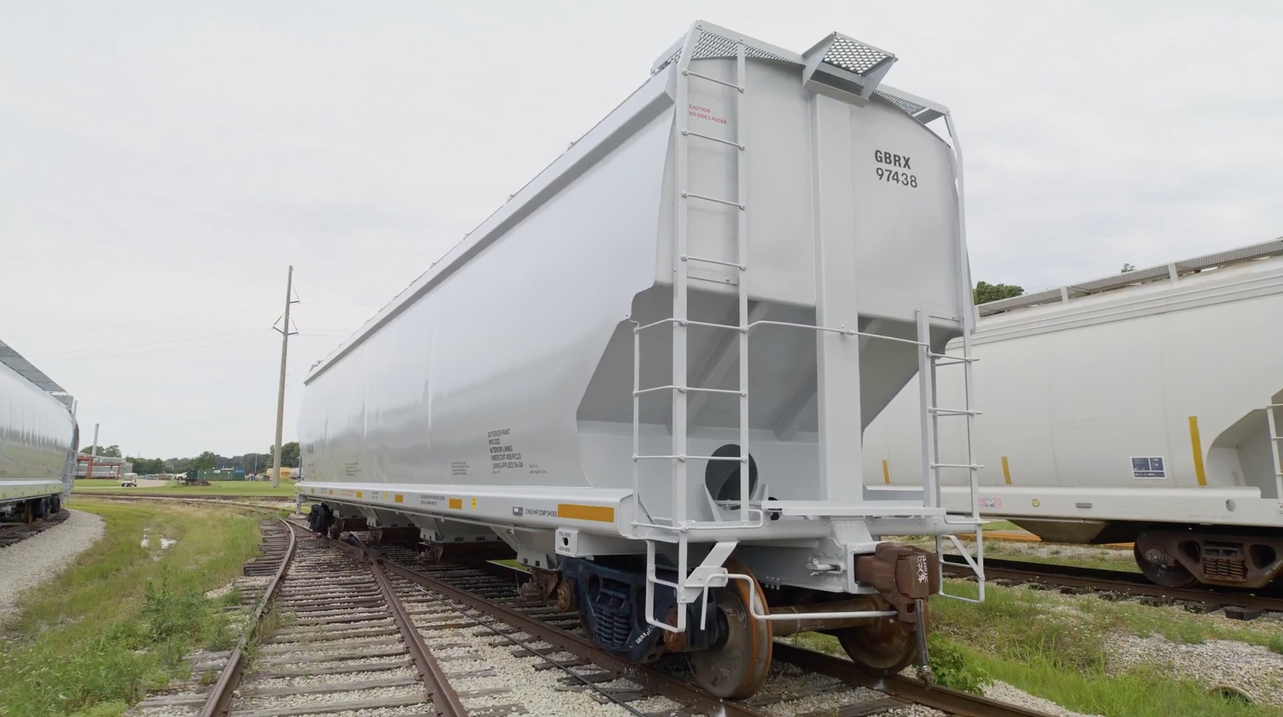 White covered hopper railcar on the railroad tracks